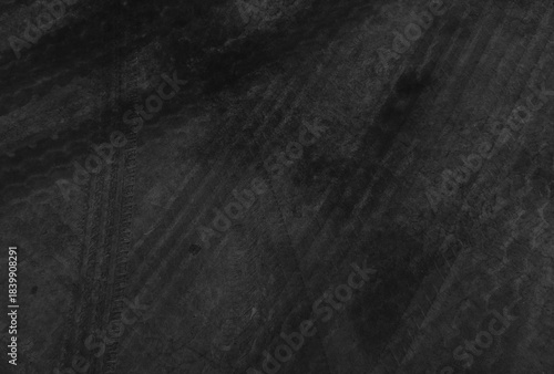 Close up black tire marks on cement floor.