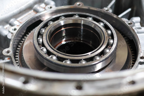 Canvas Print A close-up view of a large, high-precision radial ball bearing and internal gears inside an open automotive or industrial metal gearbox housing ready for assembly or repair