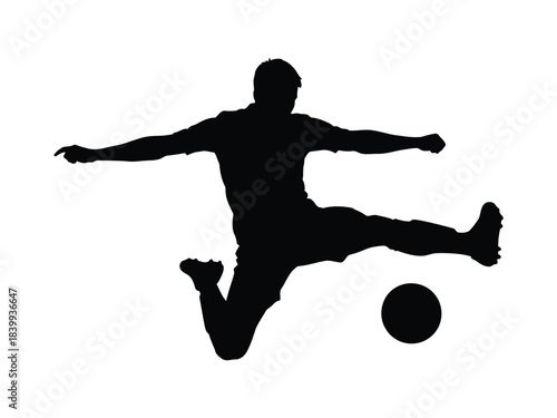 Silhouette of a soccer player kicking a ball in mid-air