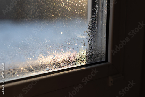 Photography Condensation forms on a window, showing the need for proper ventilation and humidity management in a home