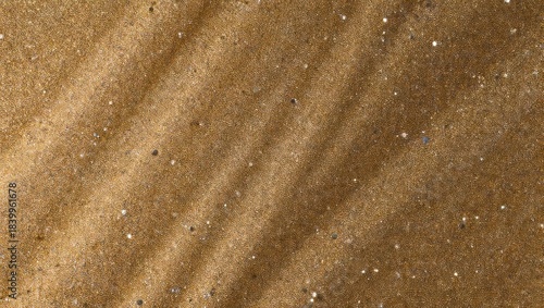 Golden brown abstract background with diagonal sandy waves and glitter specks.