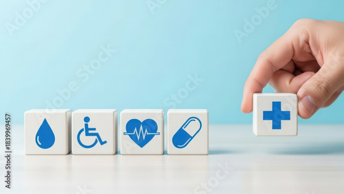 Hand places cross cube, symbolizing health, medical, social care and well-being services.