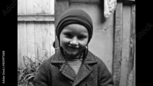 Close up, girl with cancer, old film. Touching portrait of sick child looking at camera. Smiling little kid with incurable disease. Dreadful illness of child. Archival retro 1960s. Vintage archive