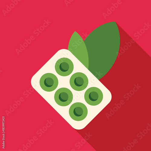 Green herbal medicine pills in a blister pack with fresh green leaves