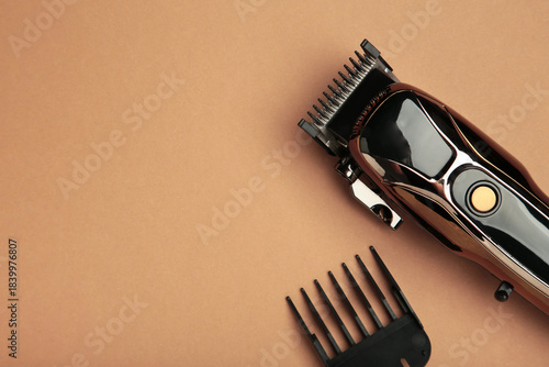 Hair clipper on brown background. Modern hair clipper.