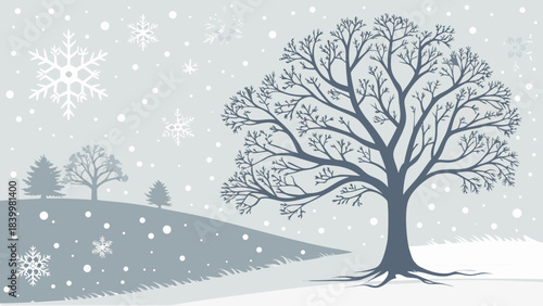 Bare tree in winter landscape with falling snowflakes and distant trees on a snowy hill in grayscale tone