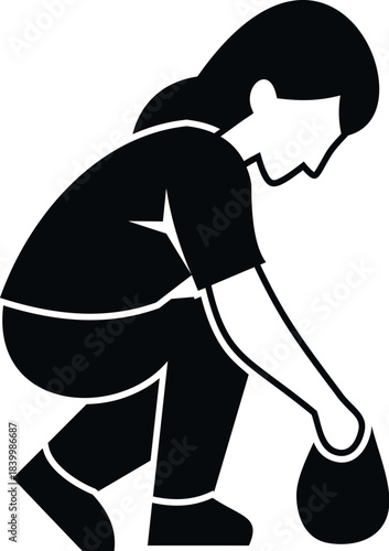 Woman squatting down picking up an object with her hand