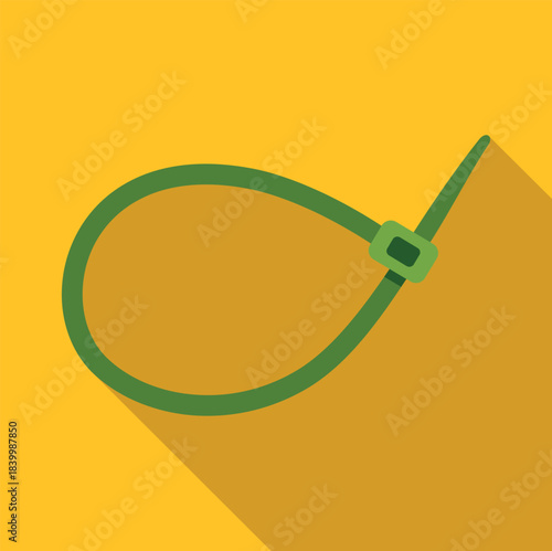 Green plastic zip tie cable fastener on a yellow background