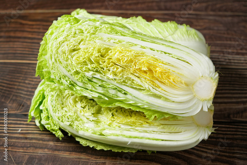 fresh chinese cabbage and a cut one on wood table.