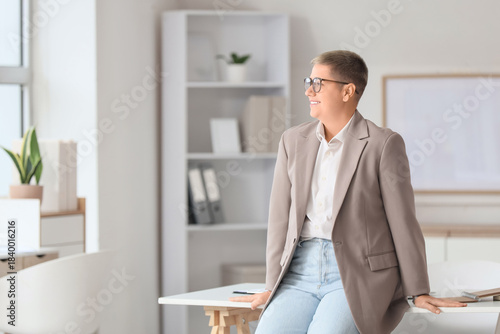 Tableau sur toile Portrait of young businesswoman with short hair in office