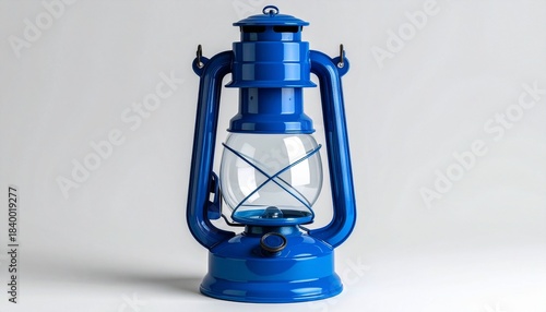 “A vintage blue kerosene lantern with glass enclosure and metal frame on white background.”