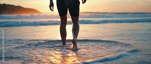 Solitary Stroll on the Shoreline: A solitary figure strides confidently through the gentle surf along the coast, embraced by the warm hues of the sunset.