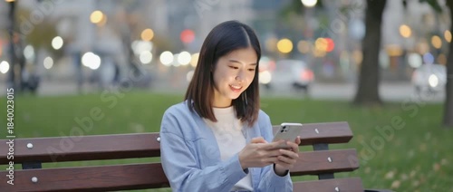 Digital Serenity: A young woman is engrossed in her phone on a park bench as the soft glow of dusk gently illuminates the scene. Capture the moment where the urban meets the individual.