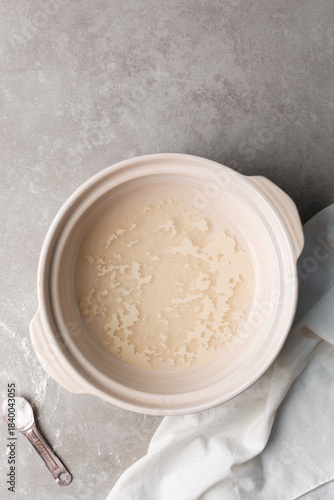 Instant dry yeast sprinkled on warm water, dry yeast granules on water