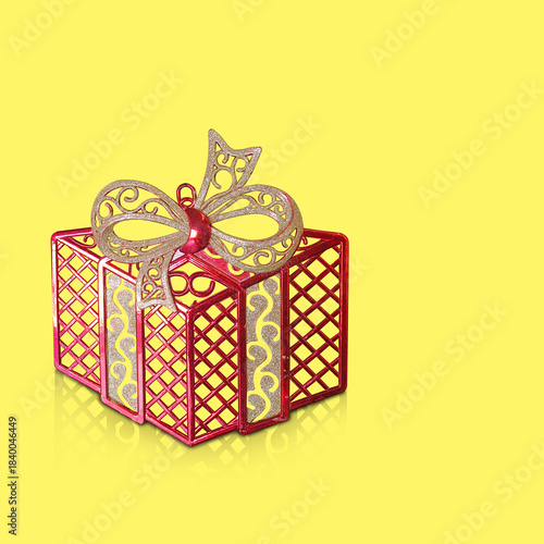 A red plastic gift box is placed on a yellow background, fashion, gift, decor, decoration, object, ancient, antique, copy space