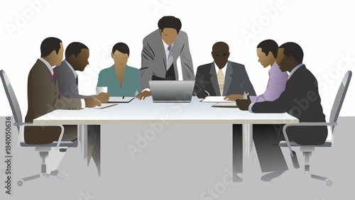 Diverse group of business professionals in a meeting around a table discussing strategy with a laptop and documents