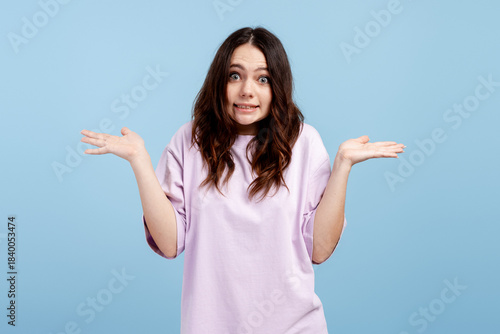 Tableau sur toile Woman shrugging shoulders, feeling confused and unsure, expressing oops moment