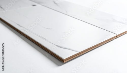 Closeup of white marble effect laminate flooring plank edge.