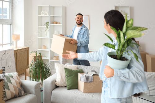 Happy young couple unpackin...