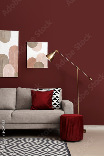 Konstfotografi Interior of stylish living room with cozy grey sofa and standard lamp near red w