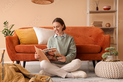 Young woman reading magazin...