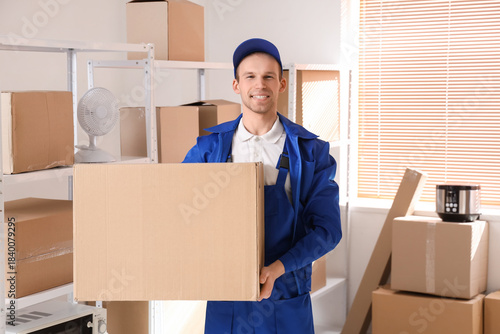 Male worker with cardboard ...