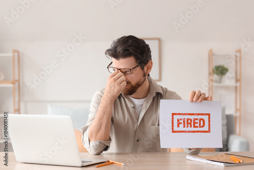 Upset young man holding pap...