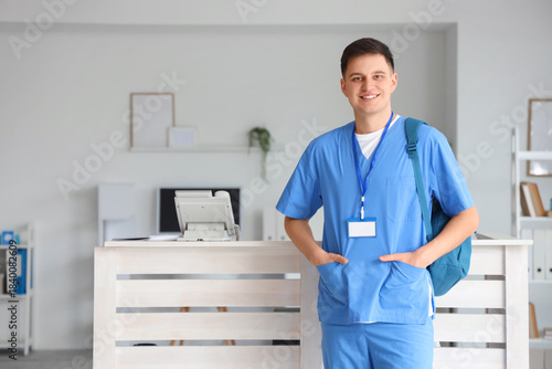 Male medical intern with ba...