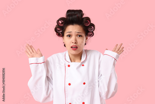 Shocked female Asian chef w...