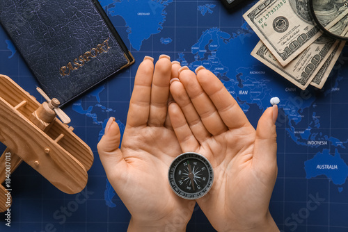 Woman holding compass on ma...