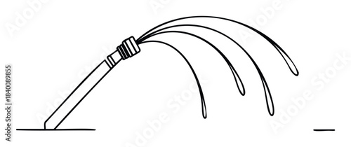 Water spraying from a garden hose on the ground creating arcs for outdoor watering and landscape maintenance applications