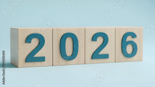 Wooden blocks spelling out the year 2026 against a light blue background