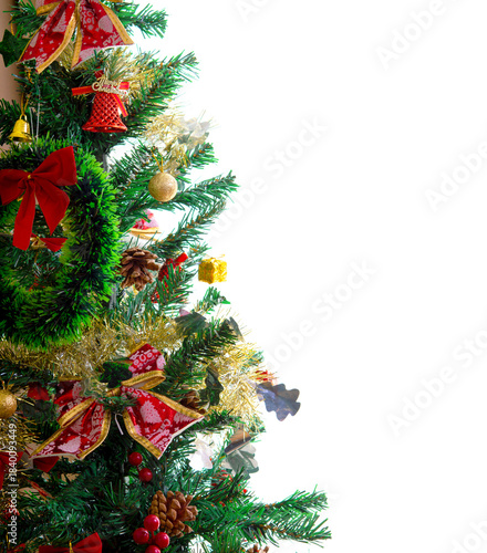 Christmas background image: gift boxes, Christmas tree decorations, red bows, and stars on top of the tree. Christmas Eve at home.  on a white background.