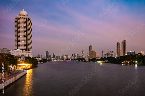 View of Chao Phraya River from Chao Phraya Sky Park. Bangkok cityscape at sunset (blue hour).