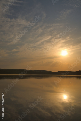 Sunset over a calm lake with atmospheric reflections in nature