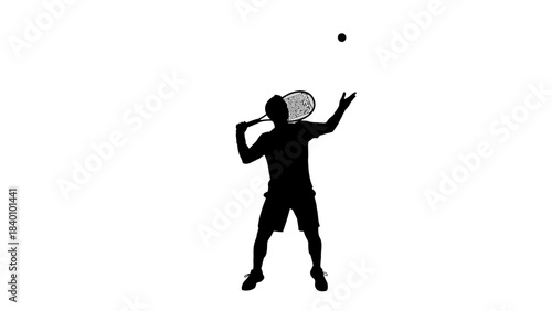 Silhouette of a tennis player serving the ball with intense focus.
