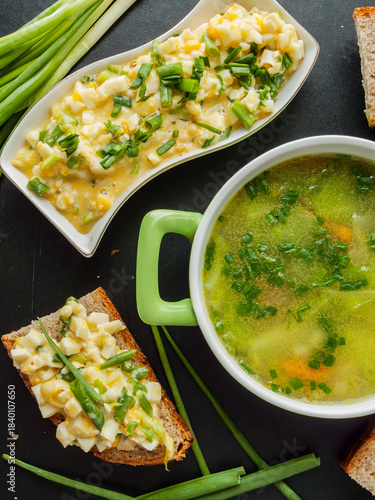 Homemade dinner healthy chicken broth with veggies and egg salad sandwiches for cold season.