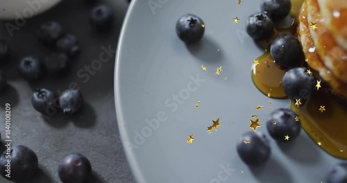 Stars appearing, syrup spreading, pancakes moving in, blueberries clustering for food styling shot