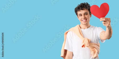 Young man with paper heart ...