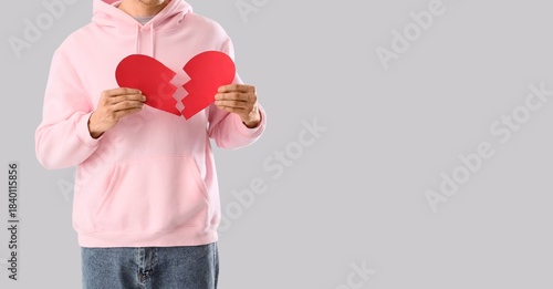 Young man with broken paper...