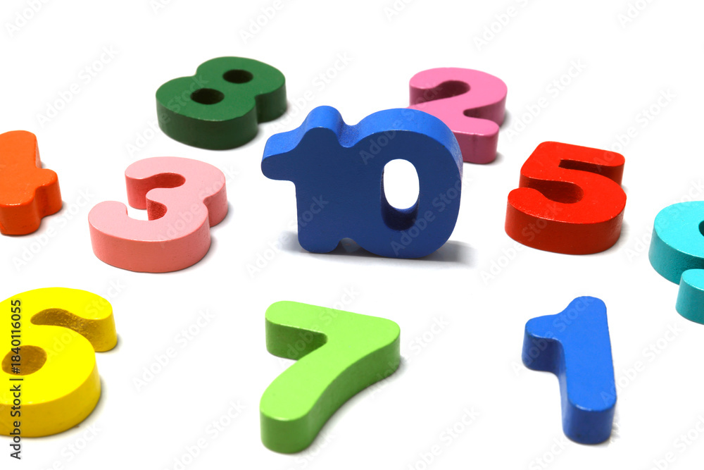 Naklejka premium Colorful wooden numbers scattered on a white background. Ideal for education, math learning, kids activities, and teaching materials, close-up