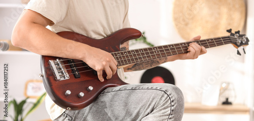Young man playing electric ...