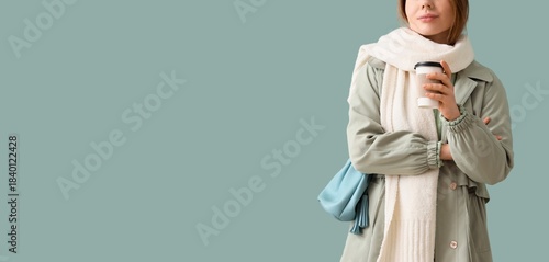 Fotografía Young woman in stylish outfit and with paper cup of coffee on mint background wi