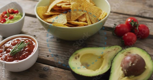 Camera panning right, chips shifting, avocado halves centering and blue circle showing fresh food