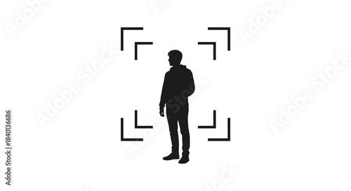 A solitary figure stands centered framed by square brackets a striking visual silhouette