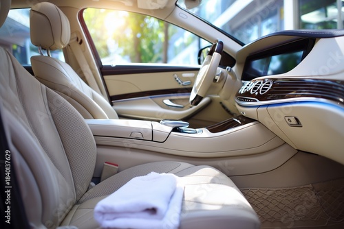 White Cleaning Towel On Perforated Beige Leather Seat - Car Cleaning