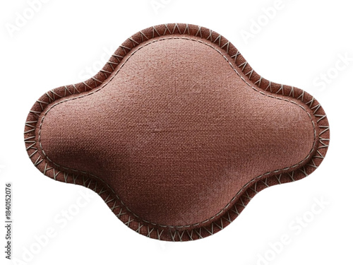 Dusty rose quatrefoil fabric patch with cross stitching isolated.