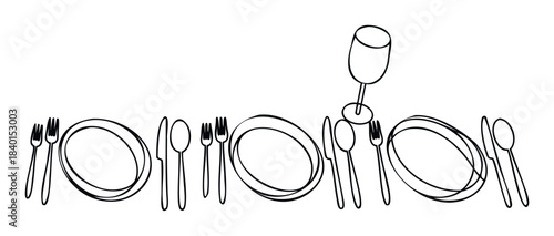 Overhead view of elegantly arranged dining place setting with plates, forks, knives, spoons, and a wine glass for a formal meal or celebration occasion