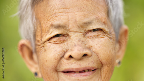 face closeup of smiling old filipino woman with grey hair, wrinkle, and missing teeth, happy senior asian, philippines, asia