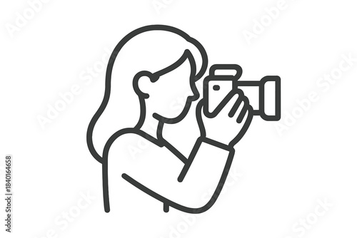 Profile view of a woman holding a digital camera taking a photo